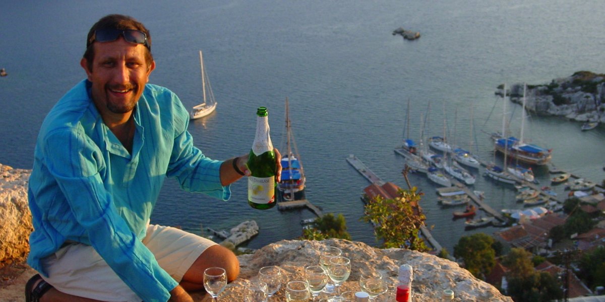 ROW Guide pouring champagne for ROW guests on a Turkey yachting tour 