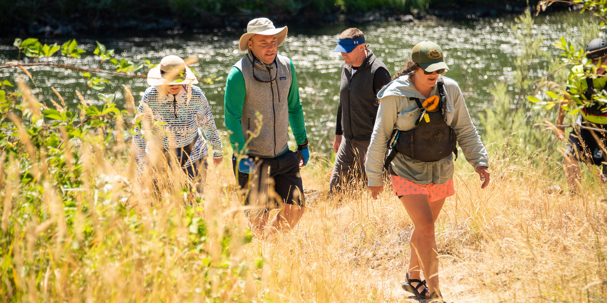 A group of whitewater rafters starting a hike off of the Rogue River