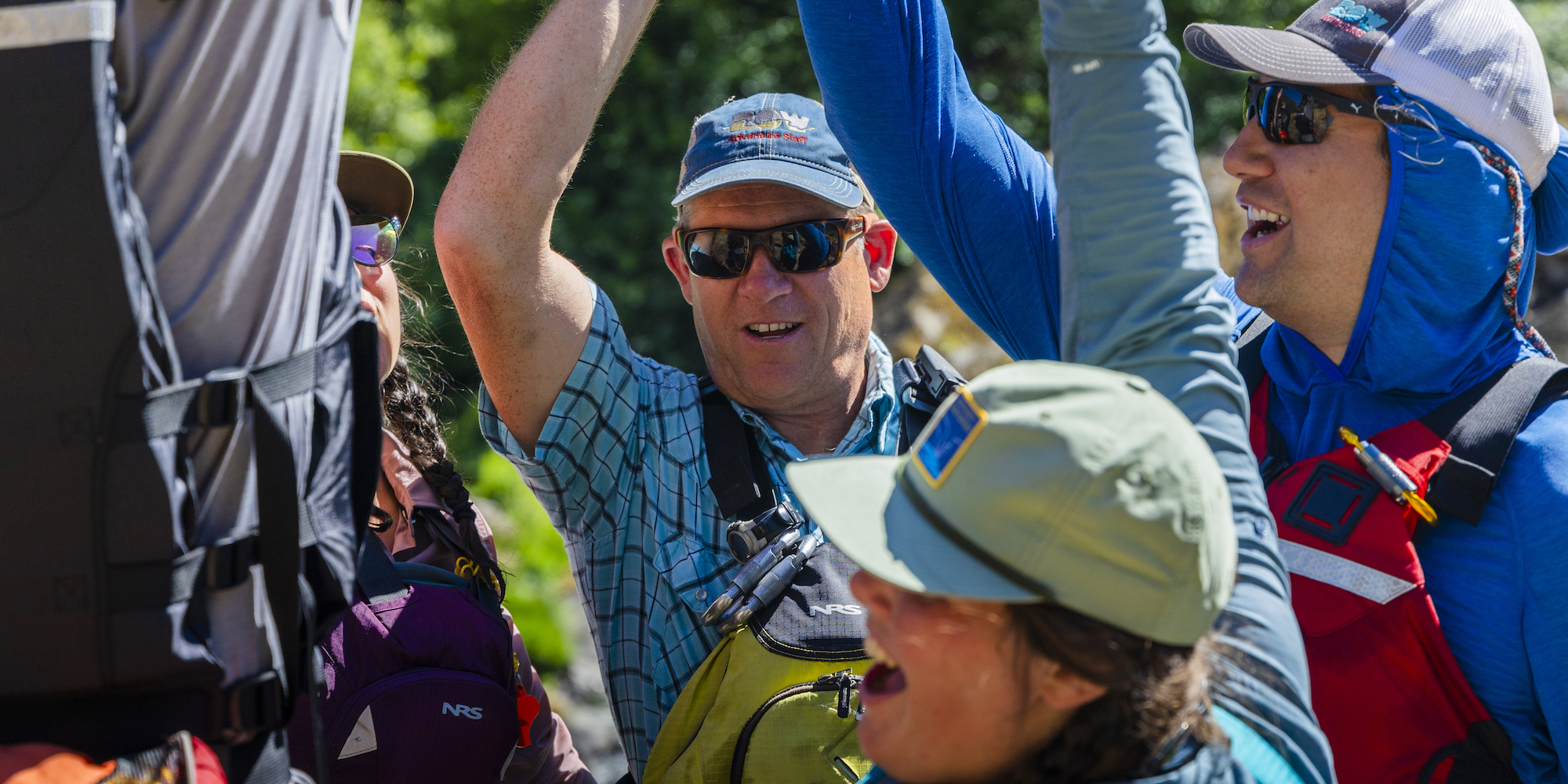 People gearing up to get on the Rogue river with sunglasses and sun shirts