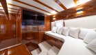 A cabin lounge inside of a yacht with a TV.