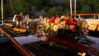 A set dining table on a Croatian yacht during sunset.