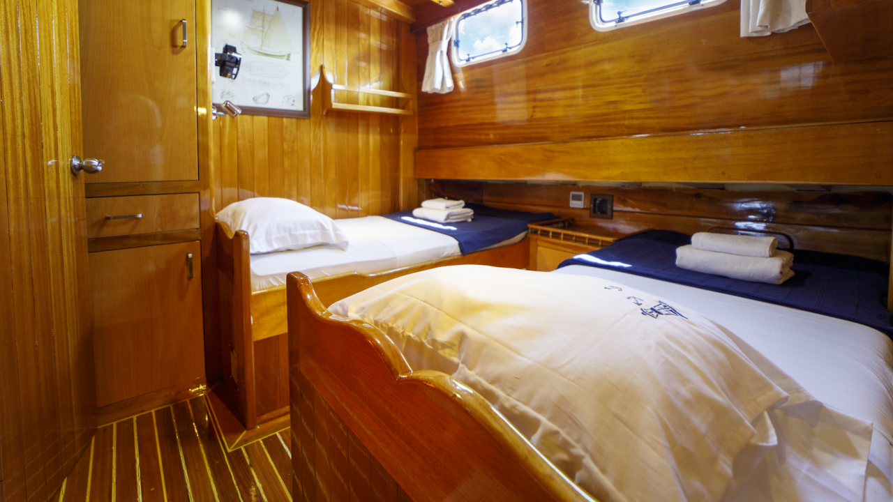 Two twin beds configured in a small room aboard a small chartered yacht in Turkey
